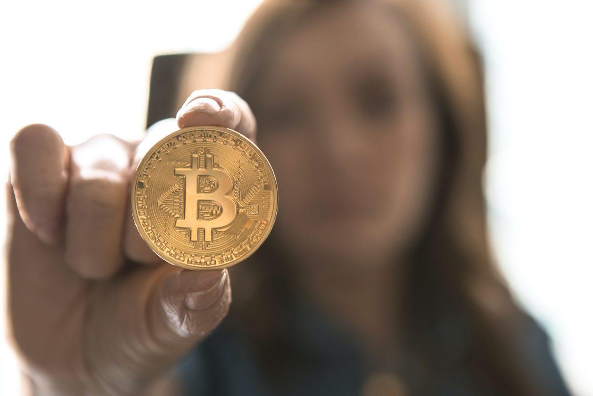 girl holds bitcoin